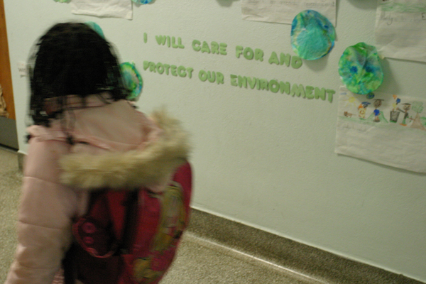 A student at the Trinidad Campus of Center City Public Charter Schools passes by part of the school's mission statement. Secular values have replaced the religious curriculum since the school became public last year.